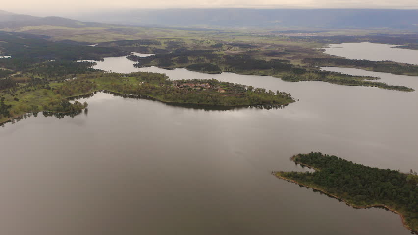 Aerial view of the ruins of Granadilla, a fortified medieval village in Cáceres, Spain, surrounded by Gabriel y Galán Reservoir. Historic walled town with castle tower and rural landscape in western Iberian Peninsula.