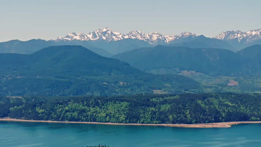 Drone view of Olympic National Park in Washington State, capturing vast forests, mountain ridges, and the wild natural landscape of the Pacific Northwest from above.