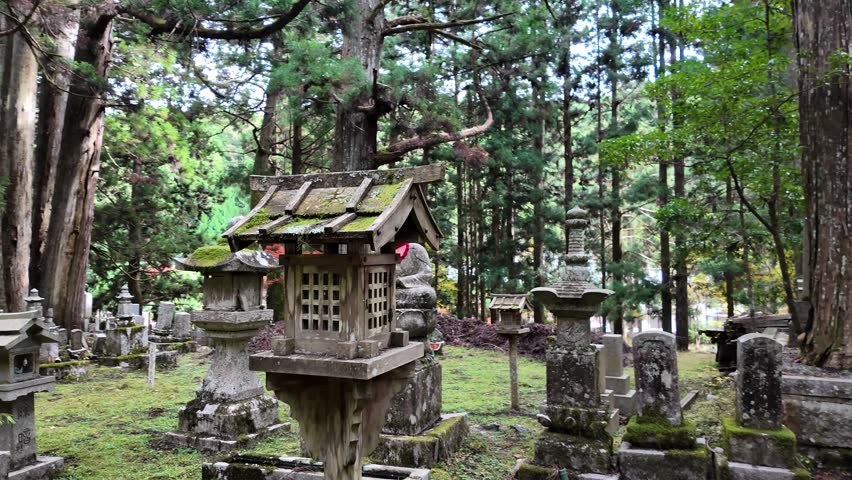 Traditional Japanese temple bell in cemetery at Mount Koya during autumn
