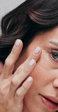 Skincare, woman and face in studio for glow, beauty and healthy skin with dermatology. Portrait, natural aesthetic and mature person with cosmetics for anti aging, smile and touch for self care - Powered by Shutterstock - Get 15% off with code: PIKWIZARD15