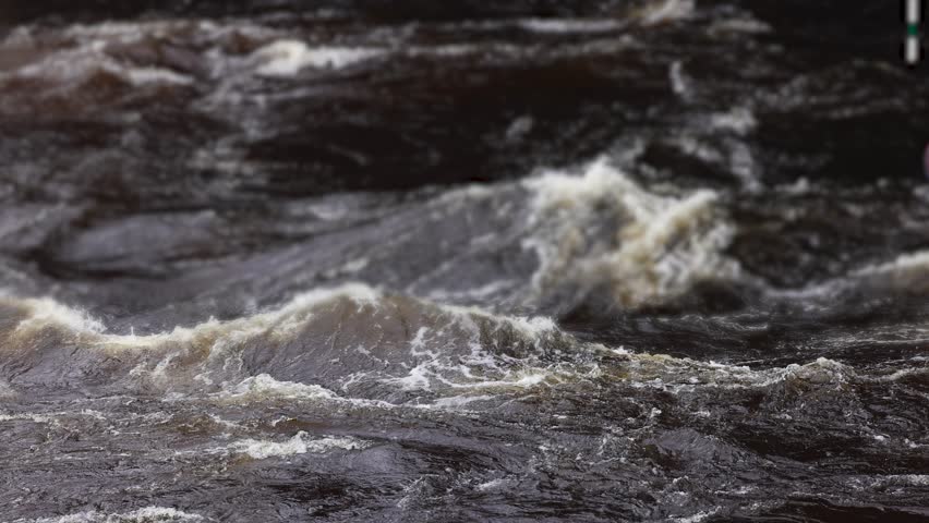 Rafting in whitewater, extreme water sports on water rapids, kayaking and canoeing tour in a mountain river,  water sports team, red and yellow raft boat full of tourists in a summer day, slow motion