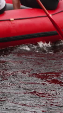 Rafting in whitewater, extreme water sports on water rapids, kayaking and canoeing tour in a mountain river,  water sports team, red and yellow raft boat full of tourists in a summer day, slow motion