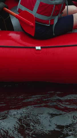 Rafting in whitewater, extreme water sports on water rapids, kayaking and canoeing tour in a mountain river,  water sports team, red and yellow raft boat full of tourists in a summer day, slow motion