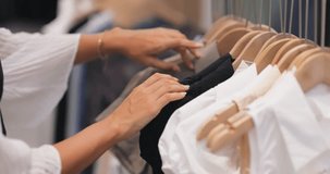Refined footage of shopper choosing white clothing pieces in modern boutique setting. Sophisticated consumer lifestyle scene perfect for fashion marketing, brand campaigns, lifestyle content. - Powered by Shutterstock - Get 15% off with code: PIKWIZARD15