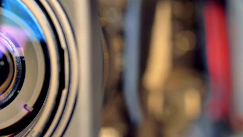 professional video camera lens. The lens coatings and intricate details are visible. open and close the aperture of the camera to adjusting, close-up.