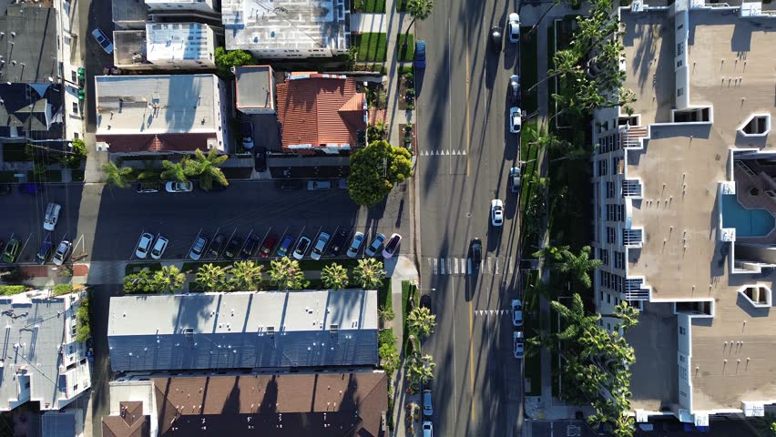 Intersection residential frame at Hermosa Ave near Ocean Blvd with mixed roof homes and apartments shaping coastal block. Roof textures, palms, subtle facade contrasts, downtown Long Beach, CA. USA