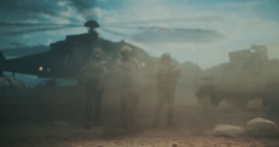 Three Male Special Forces Soldiers Move Off Helicopter Landing in a Middle East Desert, Weapons Ready, Securing High Tech Tactical Perimeter for Strike and Military War Action. Cinematic Action Scene