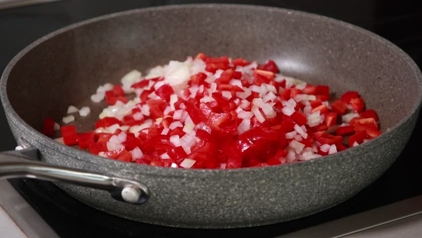 Sauteing Onion and Red Bell Peppers in Pan Cooking