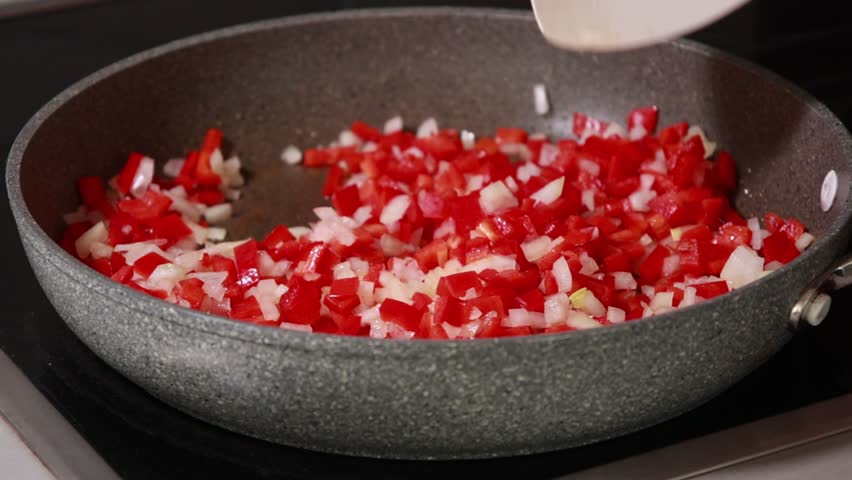 Sauteing Onion and Red Bell Peppers in Pan Cooking