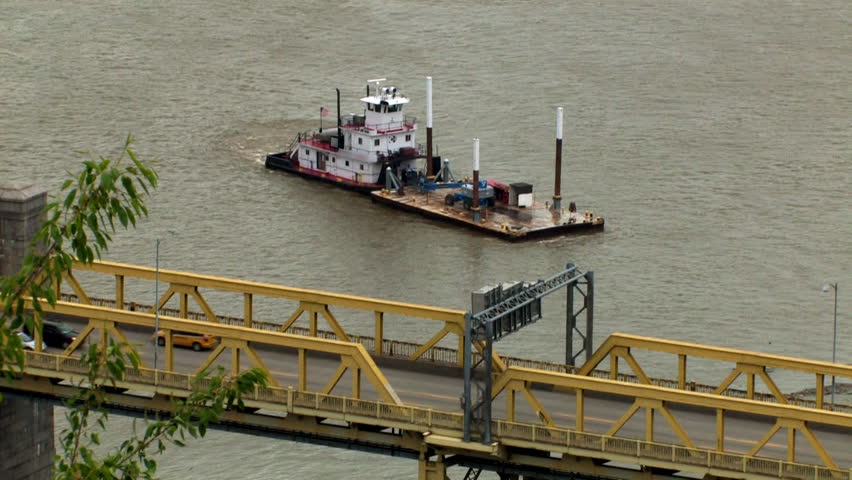A barge maneuvers on the Ohio River near the West End Bridge in Pittsburgh, PA. 