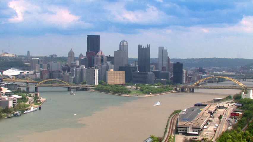 A time lapse shot of the Pittsburgh skyline.  The corporate logos on the