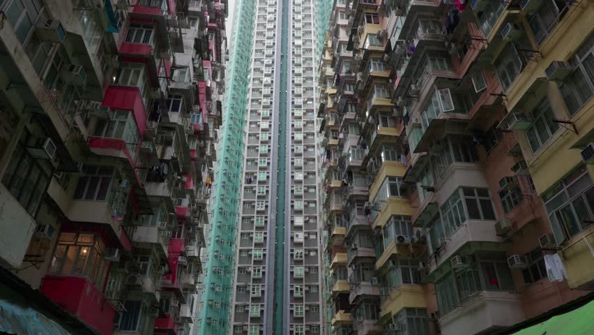 Panoramic urban view of the apartment towers at Yick Cheong Building, also known as the Monster Building, in Hong Kong on a sunny day.