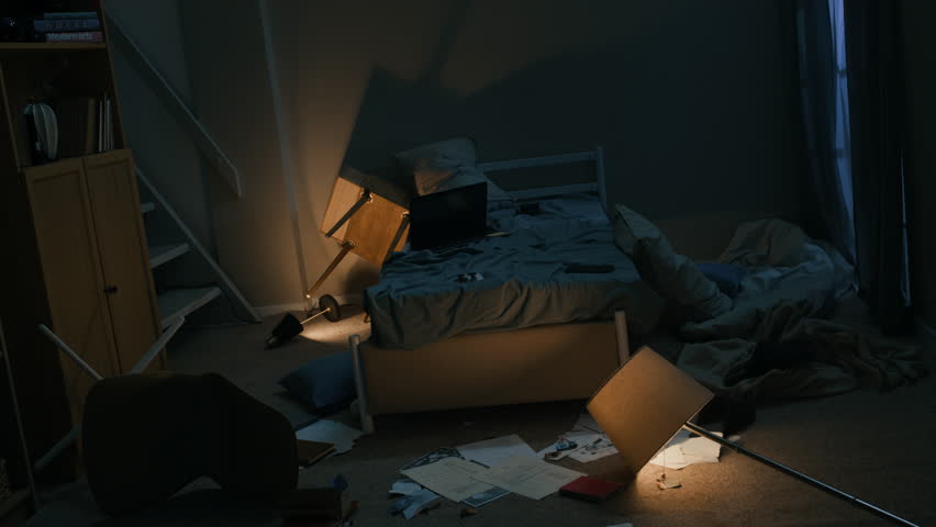 Stab long lowkey shot of messy bedroom with broken flickering lamp on floor, unmade bed and scattered papers at night