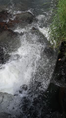 Refreshing Close Up of Rushing River Water Flow 

A high-angle, close-up shot of clear river water splashing over rocks, capturing the natural energy and refreshing movement of a wild stream.