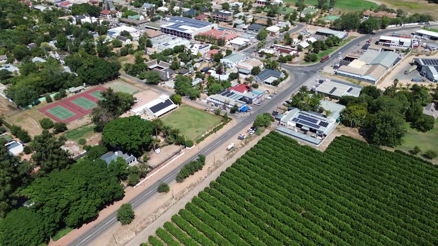 Camera panning up over the town of Clainwilliam and the main road with mountains on the horizon.