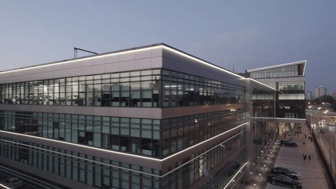 Cinematic Drone Orbit around Glowing Office Building