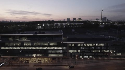 Lateral Drone Tracking Shot along Lit Office