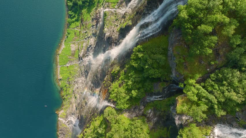 Seven Sisters Waterfall, Geiranger Fjord, Norway. Nature in fjords. Traveling through the Norwegian fjords. Scandinavia. View of nature from the drone. Vacation and travel in summer Norway.
