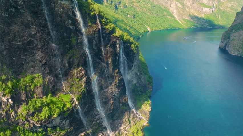 Seven Sisters Waterfall, Geiranger Fjord, Norway. Nature in fjords. Traveling through the Norwegian fjords. Scandinavia. View of nature from the drone. Vacation and travel in summer Norway.
