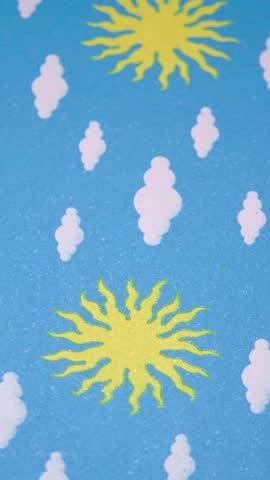 Vertical video of yellow suns and white clouds pattern on blue background, Seamless sunny sky pattern with yellow glitter suns for creative designs