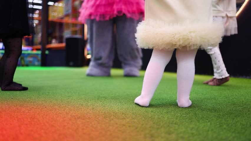 
Children Having Fun in entertainment center. Joyful Kids are Dancing with Their Daycare Pedagogue, Boys and Girls Having a Party at Daycare Preschool.