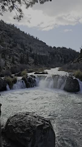 This video shows Steelhead Falls located on the Deschutes River in Central Oregon. Situated near Terrebonne and Crooked River Ranch, roughly 45 minutes from Bend. 
 A popular, family-friendly hike of approximately 0.5 miles from the trailhead leads to the falls. The area features volcanic basalt cliffs and is known for cliff jumping and swimming during the summer months. 
 The trail is open year-round, though roads in the surrounding National Grassland may have seasonal closures. The trailhead itself provides year-round access, though the trail can be slippery. 