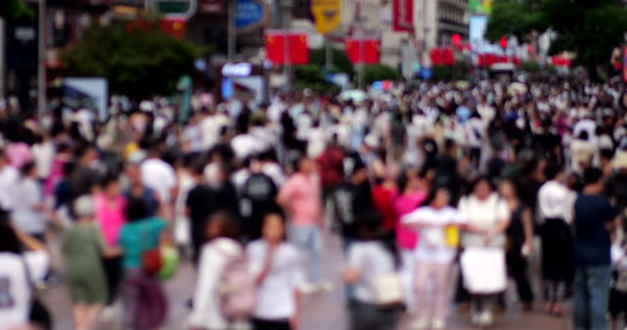 Cinematic daytime time-lapse of pedestrian street in central Shanghai during the Golden Week and National Day holiday surge. Overhead perspective features motion blur and a defocused view to ensure anonymity, perfectly demonstrate dynamic, continuous flow of tourists and shoppers. Wide alley of this famous megalopolis is filled with a bustling, constant stream of people moving through the popular shopping and dining district