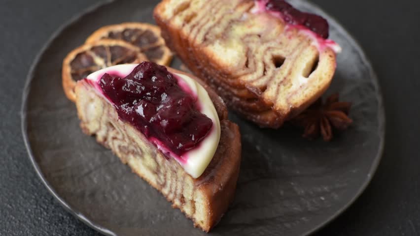 Cinnamon roll, a sweet bun with citrus, cherries, and chocolate, a Danish dessert with cream. Cinnamon roll as a food background for your design