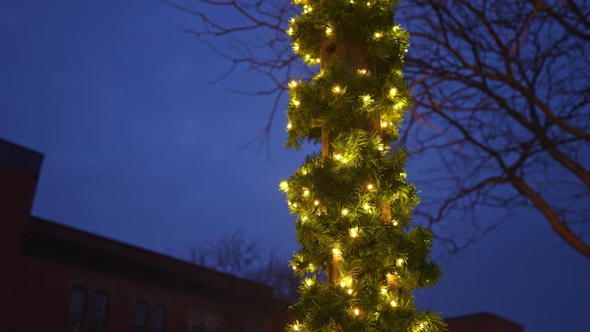 Christmas Decorations Tied to a Street Post in Downtown Bowmanville with Lights