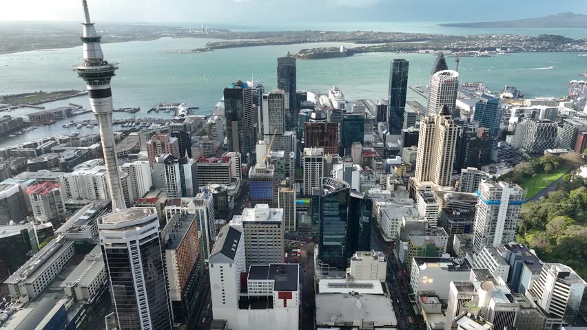 Panorama Flight through Auckland , New Zealand. Skyline. New Skyscrapers. Urban Canyon. Aerial Pedestal in Establishing Drone Shot. Glowing street lights 