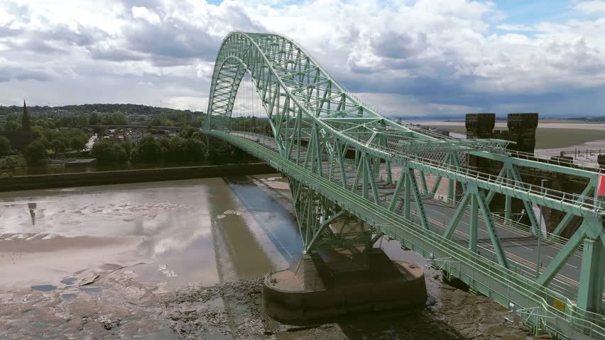 Liverpool, Merseyside, UK, September 09, 2025; aerial 4K video footage of the Silver Jubilee Bridge and Britannia Railway Viaduct over the River Mersey and Manchester Ship Canal, Runcorn, Merseyside