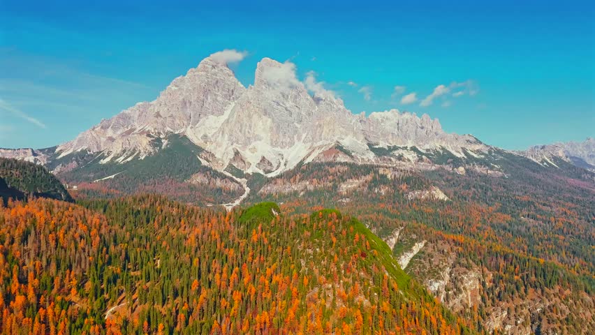 Aerial hyperlapse of high mountain peak with clouds in Dolomites, Italy