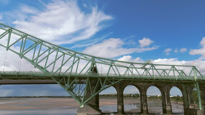 Liverpool, Merseyside, UK, September 09, 2025; aerial 4K video footage of the Silver Jubilee Bridge and Britannia Railway Viaduct over the River Mersey and Manchester Ship Canal, Runcorn, Merseyside