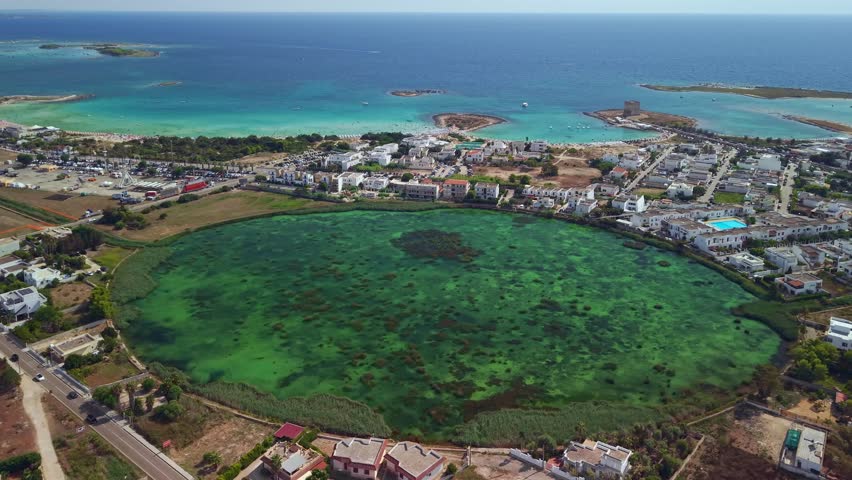 Aerial view of Bacino di Torre Chianca. Freshwater from the Idume River meets the Adriatic Sea, creating a unique coastal basin with crystal clear cold waters near Lecce, Salento, Puglia, Italy.