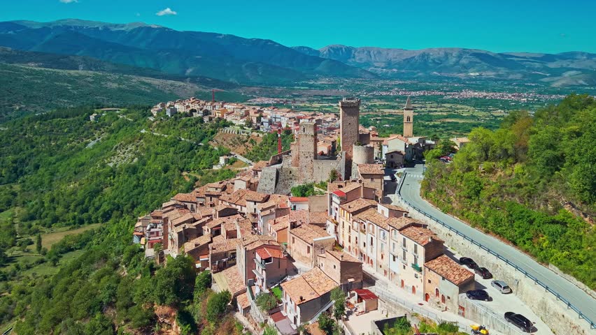 Breathtaking aerial view of Pacentro, one of Italy most beautiful medieval villages. Highlights the iconic square towers of the Caldora Castle (Castello Caldora) and stone houses perched 