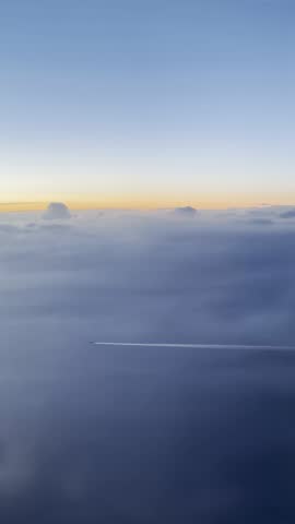 Two Airplanes Flying Over Ocean at Sunset With Clouds and Horizon