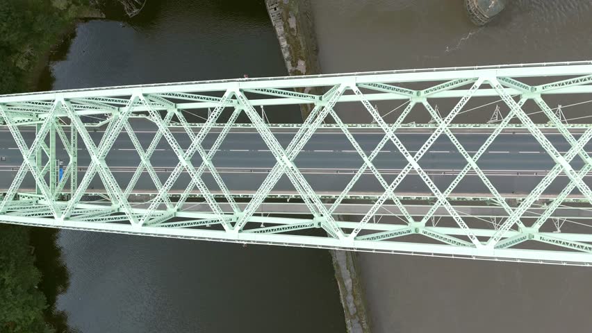 Liverpool, Merseyside, UK, September 09, 2025; aerial 4K video footage of the Silver Jubilee Bridge and Britannia Railway Viaduct over the River Mersey and Manchester Ship Canal, Runcorn, Merseyside