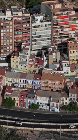 Aerial view of colorful residential buildings and urban street in Alicante Spain.