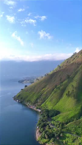 Scenic Mountain Hillside Along Lake with Blue Sky Landscape