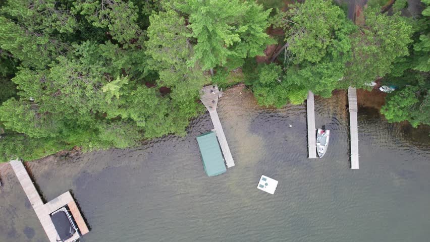 Aerial view of Eagle River Wisconsin in the Northwoods during summer.  Descending drone shot over pier.
