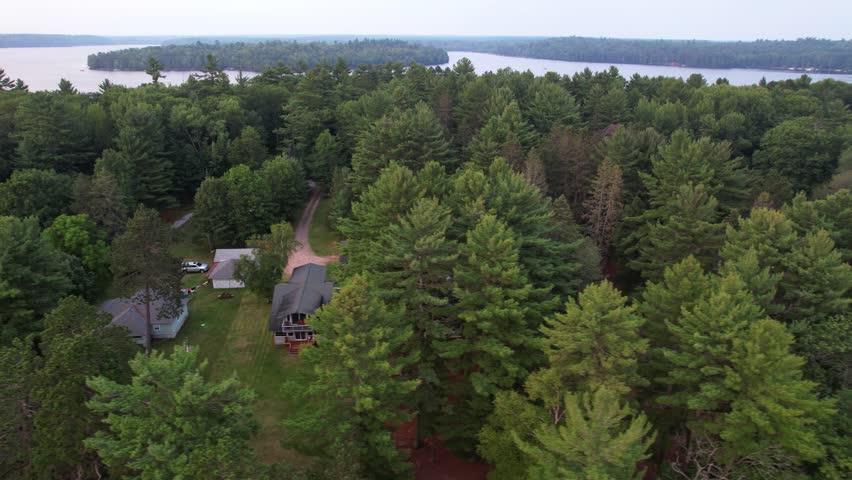 Aerial view of Eagle River Wisconsin in the Northwoods during summer.  Left to Right drone shot of lake country.