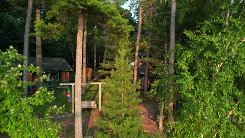 Aerial view of Eagle River Wisconsin in the Northwoods during summer.  Rising drone shot over tree line.