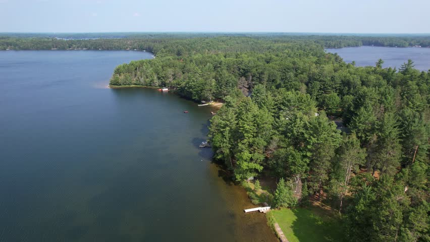 Aerial view of Eagle River Wisconsin in the Northwoods during summer.  Orbital of two lakes.
