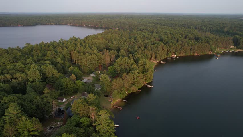 Aerial view of Eagle River Wisconsin in the Northwoods during summer.  Drone approach shot during Golden Hour.