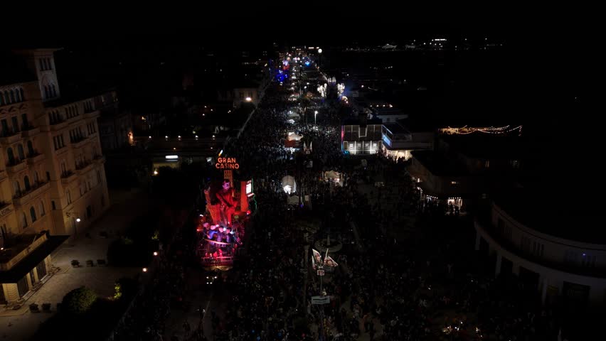 Night aerial of the Carnival parade with lighted floats in Viareggio