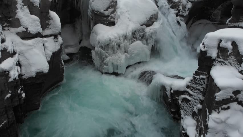 Aerial drone view of frozen Athabasca Falls canyon in winter, Jasper National Park Alberta Canada