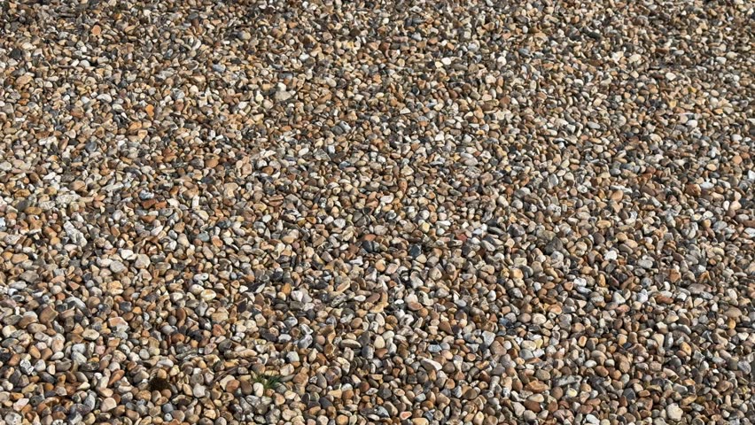 Mixed brown gravel pebble driveway panning