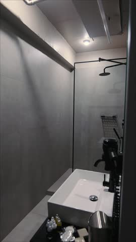 Modern bathroom interior with glass shower cabin and white sink
