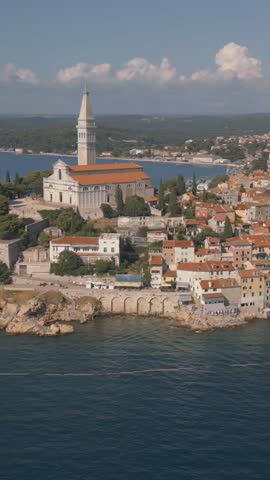 Vertical drone orbit of Rovinj old town on sunny summer day