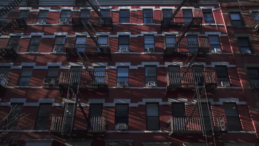 Handheld shot of a New York City apartment building.